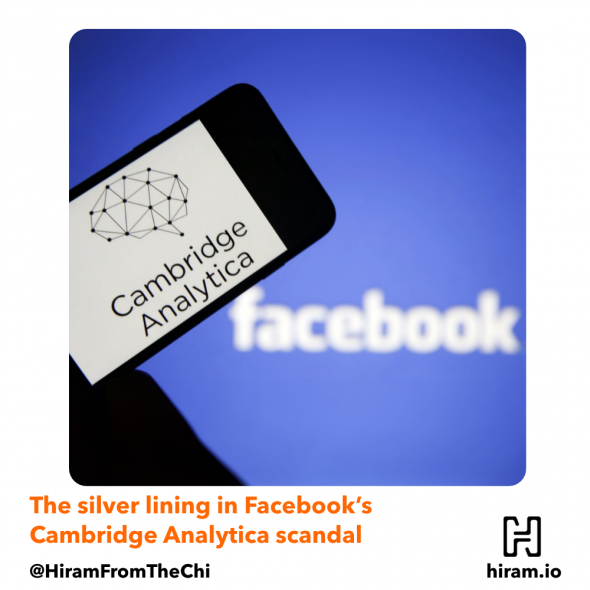 A phone with Cambridge Analytica's logo over the background of the Facebook logo.